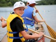 Maksym, 11, takes his turn to paddle