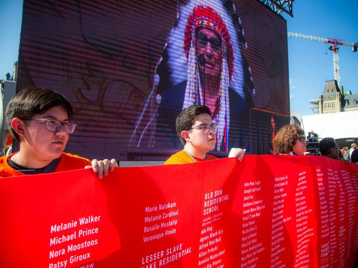  A long banner displays names of children who did not come home from residential schools.