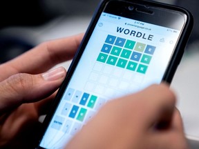 In three! A person plays the online word game Wordle on a mobile phone in 2022.