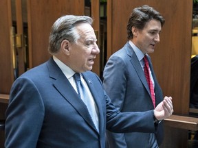 Prime Minister Justin Trudeau and Quebec Premier Francois Legault chat while walking to a meeting in Montreal, on Tuesday, December 20, 2022.