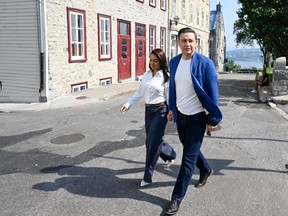 Conservative Leader Pierre Poilievre and his wife Anaida walk from a news conference in Quebec City, Wednesday, Sept. 6, 2023.