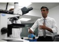 British PM Rishi Sunak with a microscope