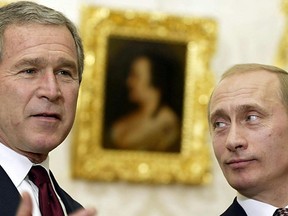 FILE: George W. Bush (L) and Russian President Vladimir Putin (R) speak to reporters 22 November 2002 at Catherine's Palace in Pushkin, Russia after their meeting there.
