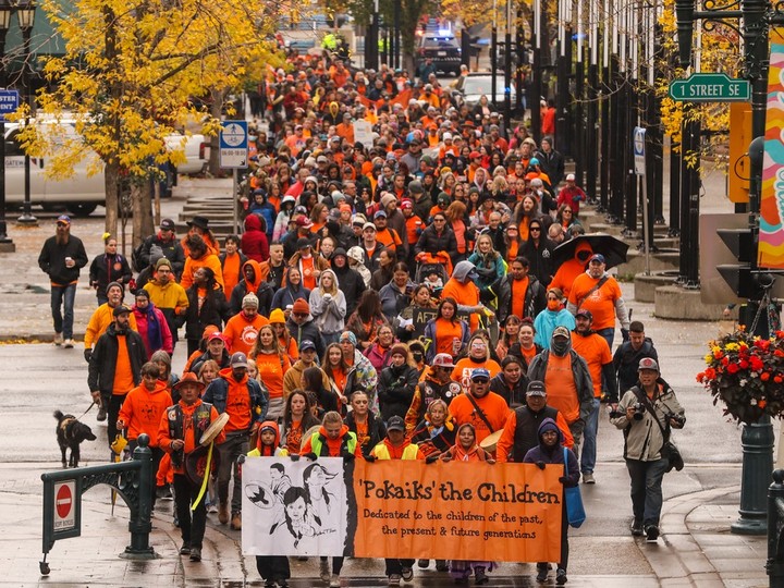  Participants take part in the annual Pokaiks ‘The Children’ Commemorative Walk & Gathering or Orange Shirt Day walk on the National Day for Truth & Reconciliation in Calgary on Saturday, Sept. 30, 2023. The walk went down Stephen Avenue from City Hall to Shaw Millennium Park.