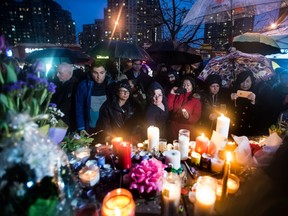 mourners with candles on Toronto street