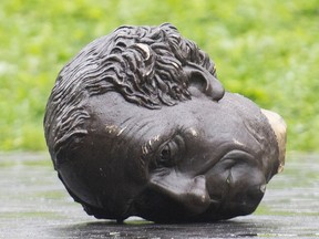 head of statue on ground