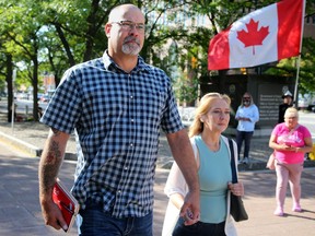 Chris Barber arrives at the Elgin Street courthouse in Ottawa Monday morning with his lawyers and partner.