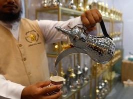 Vendor pours cup of coffee