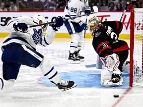The Toronto Maple Leafs' Max Domi is unable to get a clean shot on the Ottawa Senators' Anton Forsberg during third period in preseason NHL hockey action in Ottawa, on Sunday, Sept. 24, 2023.