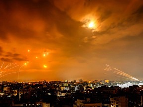 Rockets fired by Palestinian militants from Gaza City are intercepted by the Israeli Iron Dome defence missile system in the early hours of October 8, 2023.
