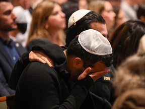 People attend a vigil for Israeli victims at the Stephen Wise Temple