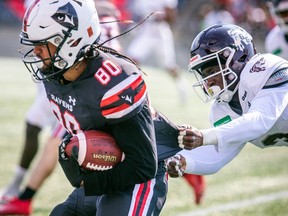 Carleton Raven's Hunter Brown tried to pull away from Gee-Gees Tolu Ahmed.