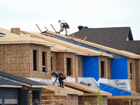 Workers on roof of new homes