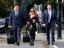 Tamara Lich, middle,  walks to the Ottawa courthouse in October with her lawyer, Lawrence Greenspon, left. File photo