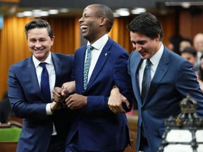 Newly elected Speaker of the House of Commons Greg Fergus is escorted into the House of Commons by Prime Minister Justin Trudeau and Conservative Leader Pierre Poilievre on Parliament Hill in Ottawa on Tuesday, Oct. 3, 2023.