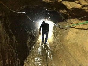 A Palestinian man walks from the Egyptian side of the border in a repaired bombed smuggling tunnel linking the Gaza Strip to Egypt in 2012. A sprawling network of Hamas tunnels under the Gaza Strip has become a primary target for the Israeli military in its stated mission to defeat Hamas.