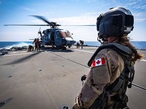 Military personnel aboard the Canadian frigate HMCS Halifax take part in an exercise in the Mediterranean in a file photo from 2019.