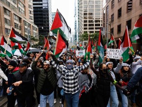 People wave Palestinian flags during a demonstration in Toronto on October 9, 2023. "I am proud to live in a country where truth cannot be put down by persecution," John Ivison writes. "But it is quite another thing to witness fellow citizens lionize rape and murder."