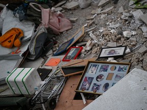 Family photos and personal items are scattered amongst the rubble of a destroyed house in Be'eri, Israel, near the border with Gaza on October 11, 2023.