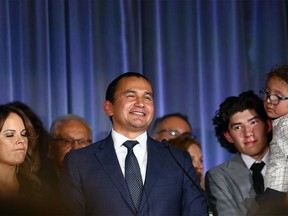 Surrounded by family, Wab Kinew gives his victory speech at the NDP provincial election night headquarters at the Hotel Fort Garry in Winnipeg on Tues., Oct. 3, 2023.