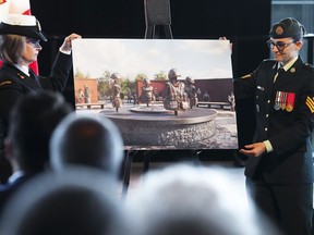 Petty Officer First Class Charlotte McShane, left, and Sergeant Missy Deschenes unveil the winning design for the national monument to Canada's mission in Afghanistan in Ottawa on Monday, June 19, 2023.