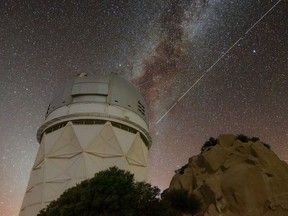 Trails in the night sky left by BlueWalker 3 are juxtaposed against the Nicholas U. Mayall 4-metre Telescope at Kitt Peak National Observatory in Arizona.