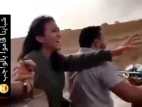 In this image from video obtained by the AP, Noa Argamani and her partner Avinatan Or, not pictured, are seized by Hamas during an attack on an Israeli music festival on Saturday, Oct. 7.