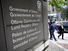 Trucker defendant near courthouse sign