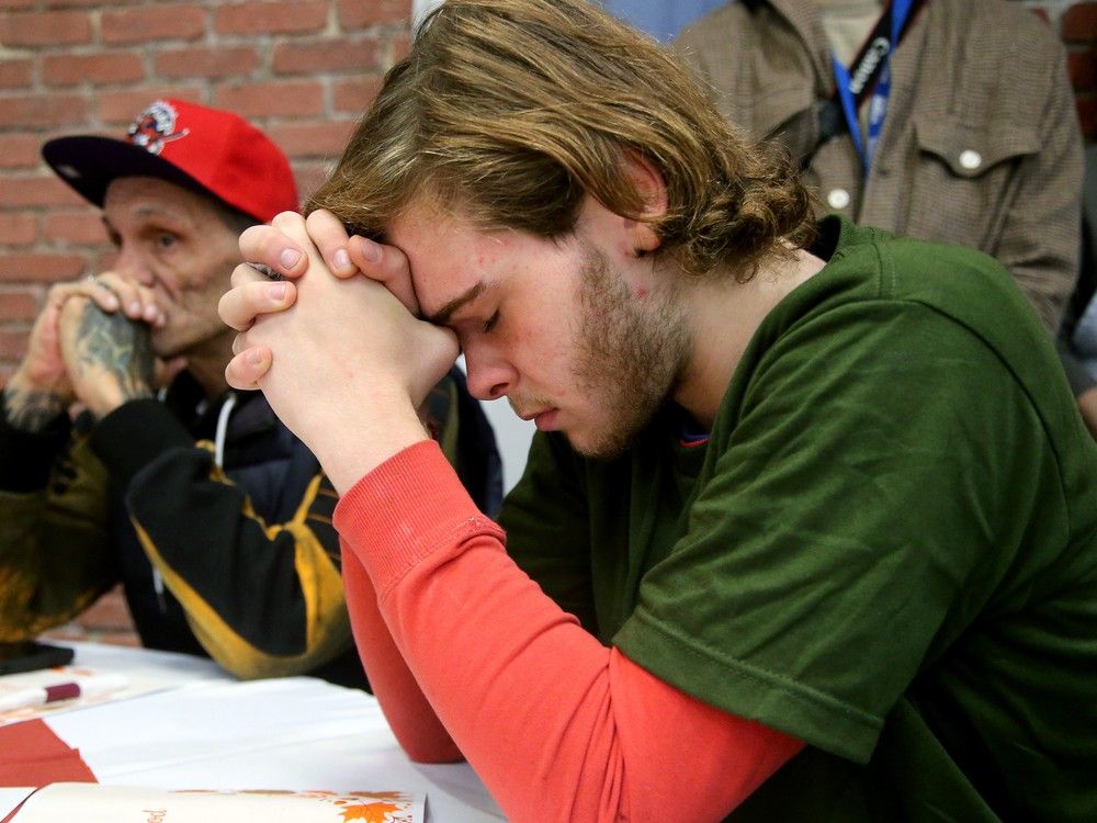 Seventeen-year-old Noah Berthelotte, who has been in the system since he was 12 years old, he said, quietly says grace before the meal is served. 