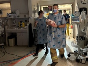 Firefighters and hospital staff relocating babies from ICU to CHEO