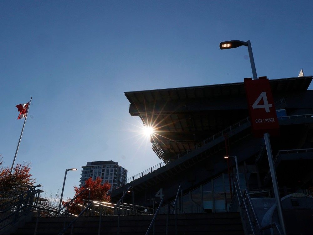 An eastern view of the north-side stadium grandstand at Lansdowne Park with a residential condominium building in the background.