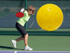 senior plays pickleball