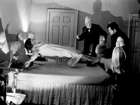 Suspended in mid-air by unknown influences, bedeviled Linda Blair startles Max von Sydow and Jason Miller who appear as priests in The Exorcist.