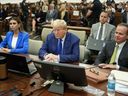 Former president Donald Trump, centre, flanked by his defence attorneys, Alina Habba, left, and Chris Kise, waits for the continuation of his civil business fraud trial at New York Supreme Court, Wednesday, Oct. 25, 2023, in New York.