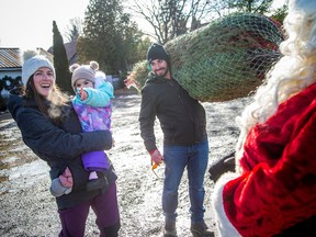 It was a perfect day to hit the Fallowfield Tree Farm to pick and cut the perfect Christmas tree, Sunday, Nov. 19, 2023. Gabriel Xerri loads up his family's Christmas tree onto the horse-drawn wagon Sunday afternoon. Cassandra Roeski holds almost two-year-old Fiona Xerri. The family was also lucky enough to see Santa on Sunday.