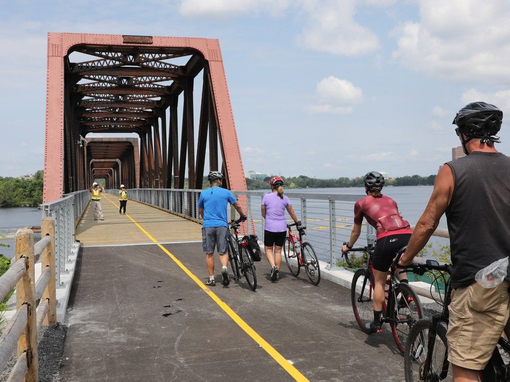 A file photo shows first-day users as the Chief William Commanda Bridge reopened for cyclists and pedestrian access on Aug. 4.