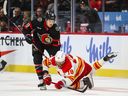 Drake Batherson of the Ottawa Senators battles for the puck with A.J. Greer of the Calgary Flames during the third period at Canadian Tire Centre on Nov. 11, 2023 in Ottawa, Ontario, Canada.