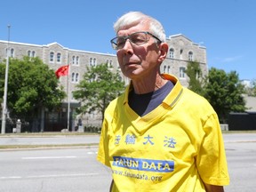 Gerry Smith stands in front of the Chinese embassy in Ottawa on July 18, 2019, wearing the Falun Gong shirt he was asked to remove by the CEO of the city's Dragon Boat festival that June.