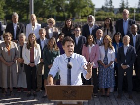 Prime Minister Justin Trudeau speaks to reporters as cabinet members look on during the Liberal cabinet retreat in Charlottetown, P.E.I. on Aug. 23, 2023.