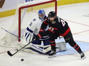 Ottawa Senators' Rourke Chartier and Tampa Bay Lightning goaltender Jonas