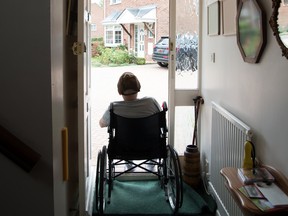 Person in wheelchair in own house