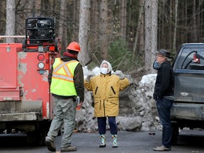 Protesters Judie Boland (centre) and Christophe Elie (right) try to talk to a tree-cutting crew member at the edge of the the Hunt Club Forest Monday. Boland, who has been walking in the forest since 1979, says she and a handful of others from the Save The Hunt Club Forest group got word the Ottawa Airport Authority was moving ahead with cutting down the local forest Monday morning.