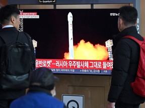 People watch a television screen showing a news broadcast with a picture of North Korea's latest satellite-carrying rocket launch, at a railway station in Seoul on November 22, 2023. Photographer: Jung Yeon-Je/AFP/Getty Images