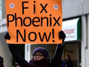 Phoenix pay system protester with sign