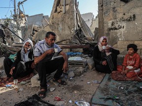 Family drinks tea amid the rubble, Gaza