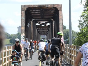 Cyclists cross The Chief William Commanda Bridge