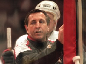 Former Senators coach Jacques Martin draws plays at a practice.