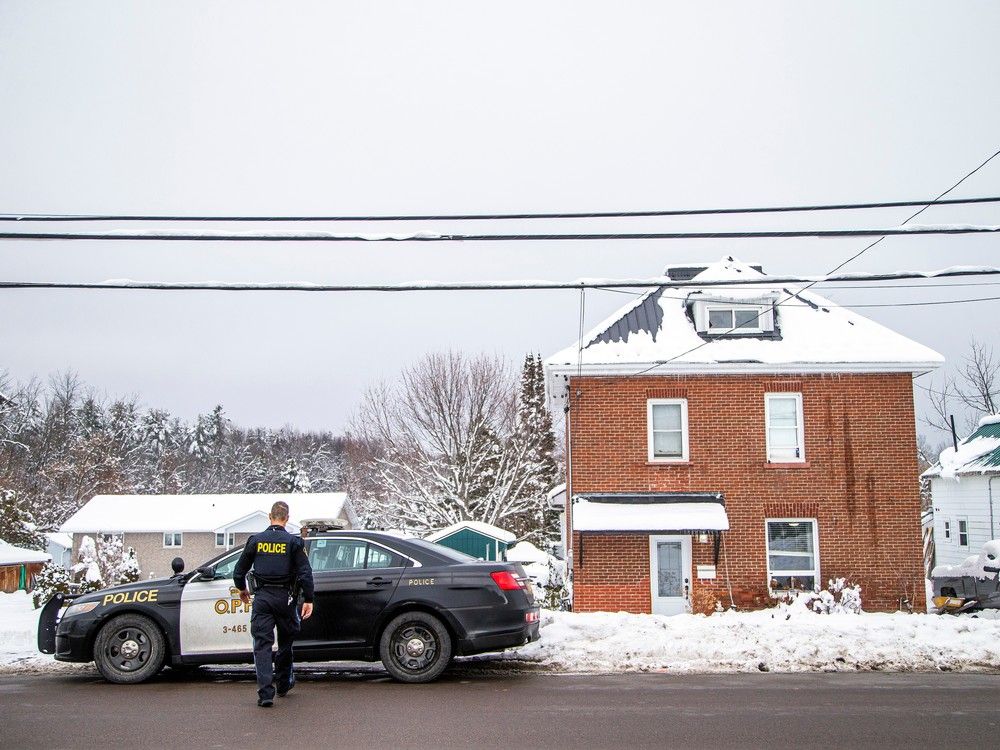 An OPP officer on the scene on River Road in Arnprior, where an overnight incident left two people with unspecified injuries and three other individuals arrested and charged. 