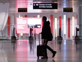 Travellers make their way through Pearson International Airport in Toronto Monday, Nov. 14, 2022.