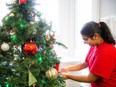 Student decorates Christmas tree